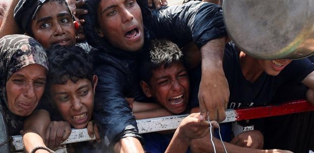 Palestinos se aglomeram na fila de distribuição de comida na cidade de Gaza