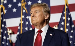 Donald Trump with US flags in the background