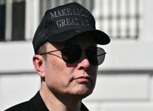 Elon Musk with Make America Great Again cap, brand of the Trump administration
